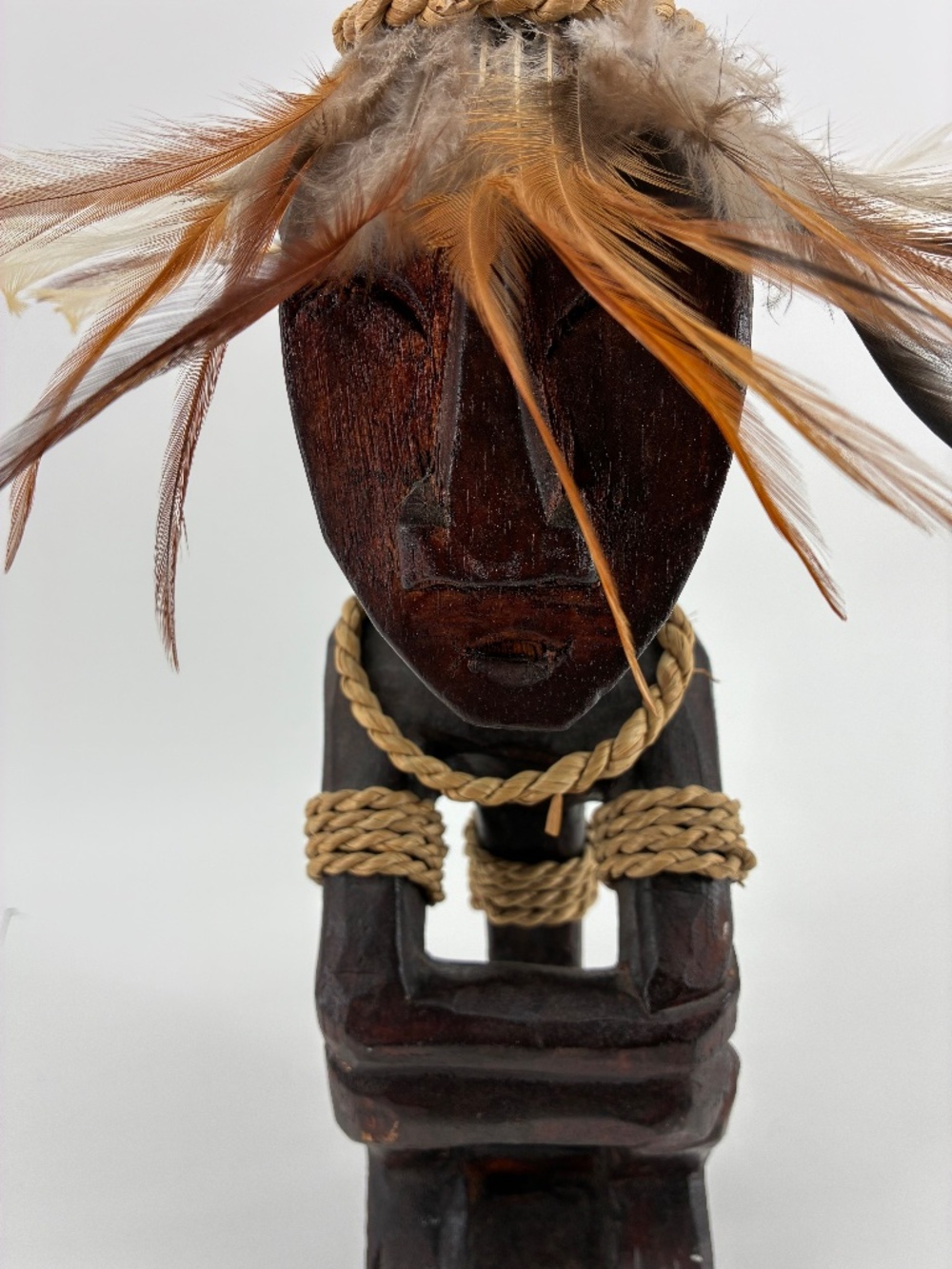 Hand-Carved Dark Brown Tribal Statue with Feathered Headdress